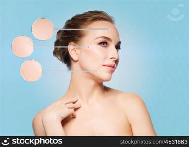 beauty, people and skin care concept - beautiful young woman touching her face over blue background
