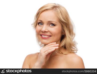 beauty, people and skincare concept - smiling woman with bare shoulders touching face