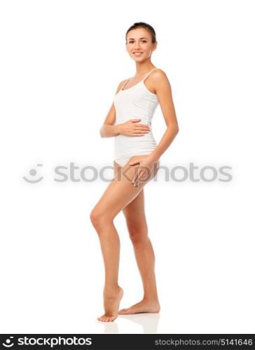 beauty, people, anticellulite and bodycare concept - beautiful young woman in white underwear. beautiful young woman in white underwear