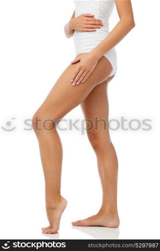 beauty, people, anticellulite and bodycare concept - legs of beautiful young woman in white underwear. legs of beautiful young woman in white underwear