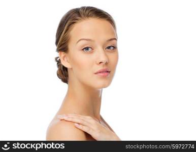 beauty, people, body care and health concept - smiling young woman face and hand on bare shoulder