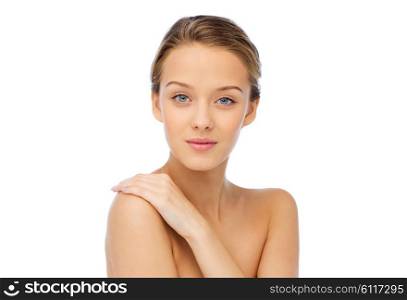 beauty, people, body care and health concept - smiling young woman face and hand on bare shoulder