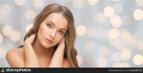 beauty, people, hair care, holidays and health concept - beautiful young woman face over lights background