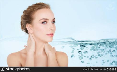 beauty, people, moisturizing and skincare concept - beautiful young woman face and hands over white background