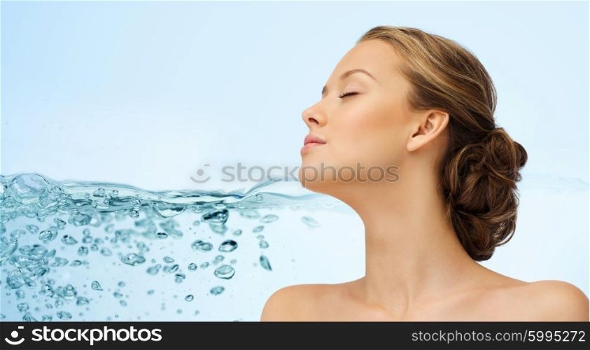beauty, people, moisturizing, skin care and health concept - young woman face with closed eyes and shoulders over water splash background