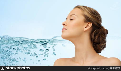 beauty, people, moisturizing, skin care and health concept - young woman face with closed eyes and shoulders over water splash background