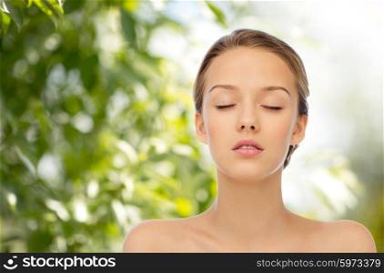 beauty, people, organic, eco and health concept - young woman face with closed eyes and shoulders over green natural background