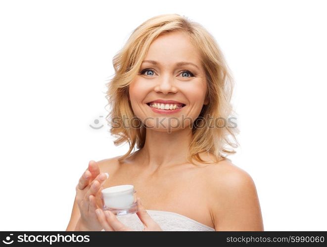 beauty, people, skincare and cosmetics concept - happy woman with cream jar