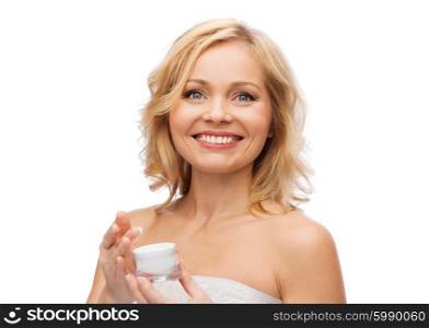 beauty, people, skincare and cosmetics concept - happy woman with cream jar