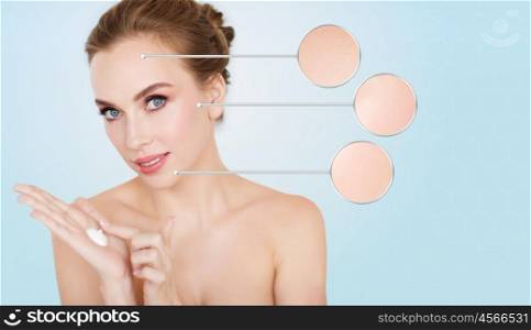 beauty, people, skincare and cosmetics concept - happy young woman with moisturizing blue on hand
