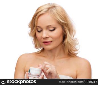 beauty, people, skincare and cosmetics concept - middle aged woman with cream jar