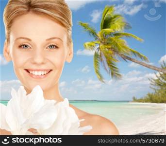 beauty, people, travel and health concept - beautiful young woman with bare shoulders over tropical beach background