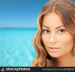beauty, people, vacation and health concept - beautiful young woman face over blue sea and sky background