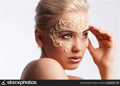 beauty portrait of a blonde girl with decorative make up