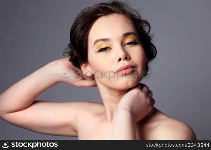 Beauty portrait of a pretty young woman with professional makeup. Shallow depth of field.