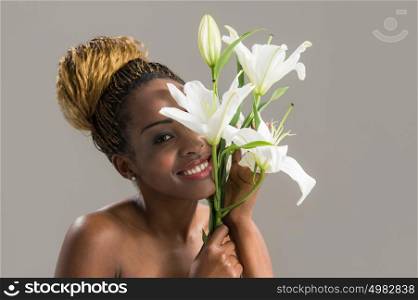 Beauty portrait of a sensual African woman with lily flower