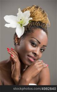 Beauty portrait of a sensual African woman with lily flower