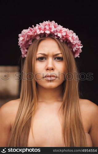 Beauty portrait of attractive blond girl with a beautiful pink headband