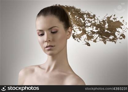 beauty portrait of blonde woman with naked shoulders and long smooth hair melting in paint
