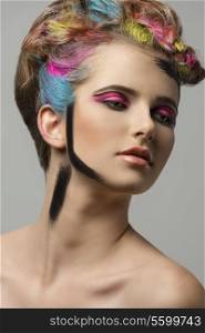 beauty portrait of pretty girl with creative painted colorful hair-style and make-up. Artistic close-up