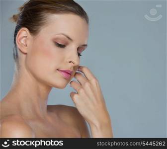 Beauty portrait of relaxed young woman isolated on gray