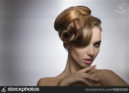 beauty portrait of sexy girl with charming expression posing with fashion elegant hair-style and stylish make-up