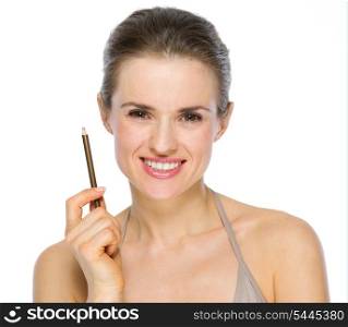 Beauty portrait of smiling young woman holding brown eye liner