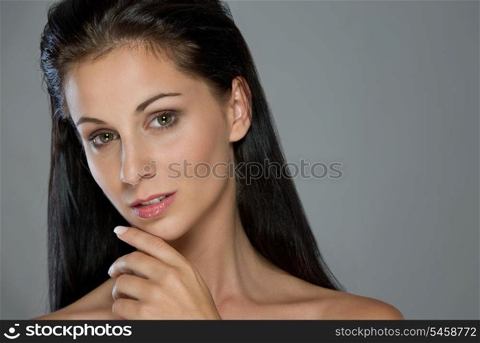 Beauty portrait of thoughtful girl on gray background