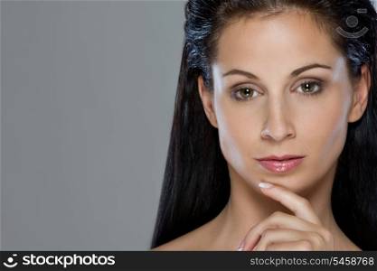 Beauty portrait of thoughtful girl on isolated on gray