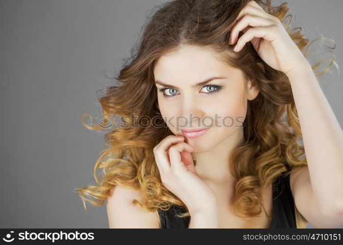 Beauty portrait of young attractive woman, isolated on gray background