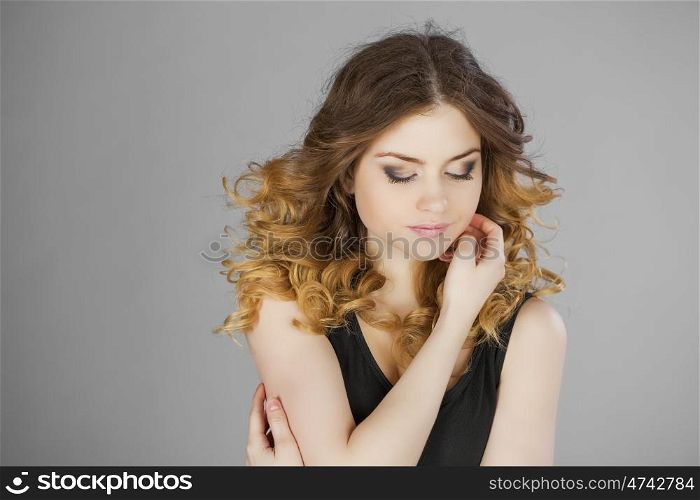 Beauty portrait of young attractive woman, isolated on gray background