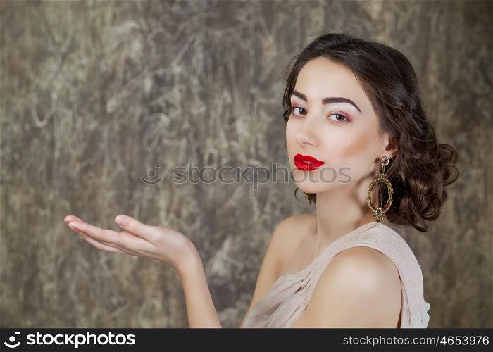 Beauty portrait of young attractive woman on dark studio wall