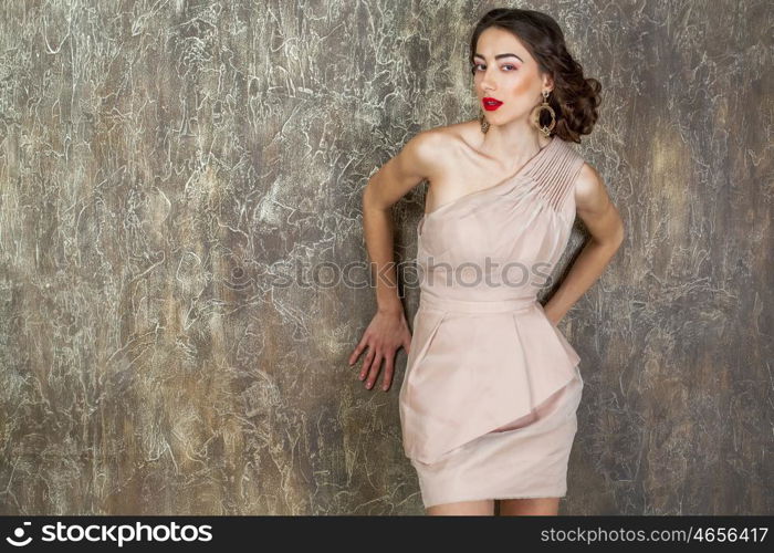 Beauty portrait of young attractive woman on dark studio wall