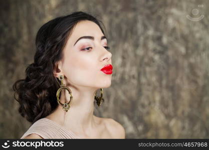 Beauty portrait of young attractive woman on dark studio wall