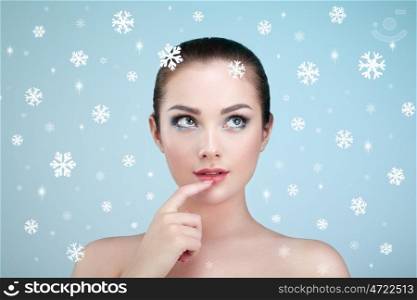 Beauty portrait of young beautiful woman over snowy. Christmas background. New yaer holidays and people concept