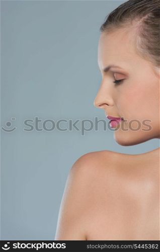 Beauty portrait of young woman in profile isolated on gray