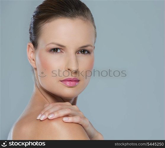 Beauty portrait of young woman isolated on gray