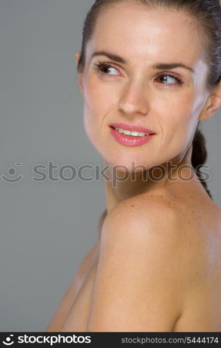 Beauty portrait of young woman looking on copy space isolated on gray background