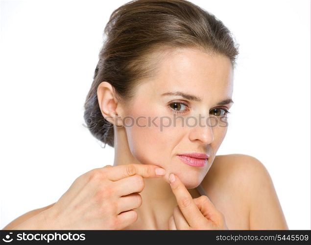 Beauty portrait of young woman squeezing acne