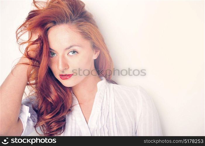Beauty portrait. Red haired model with sensual look