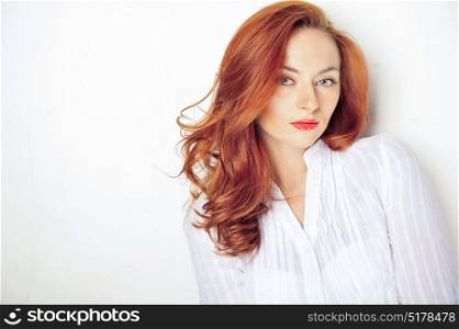 Beauty portrait. Red haired model with sensual look