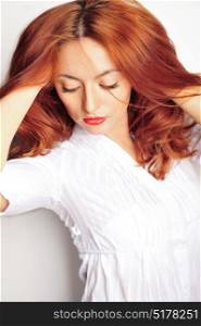 Beauty portrait. Red haired model with wavy soft hair close up