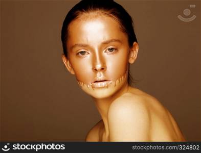 Beauty portrait with foundation makeup over face on brown background