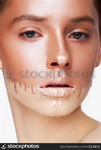 Beauty portrait with foundation makeup over face on white background with liquid foundation drops