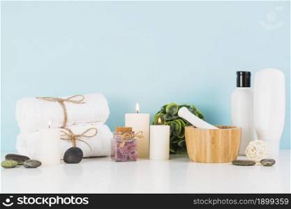 beauty products with illuminated candles front blue wall. Resolution and high quality beautiful photo. beauty products with illuminated candles front blue wall. High quality beautiful photo concept