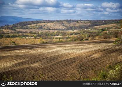 Beauty rural landscape of a clean plowed field and small village