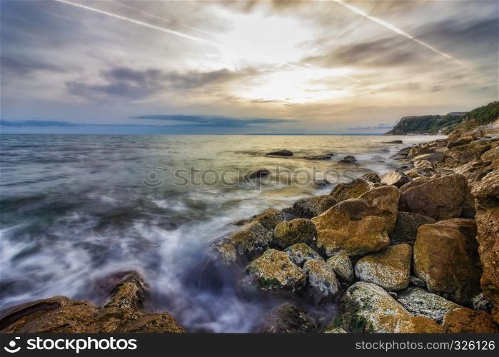 Beauty sea rocky coast with color moss on the stones. Black sea