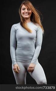 Beauty seducive shape fit body concept. Attractive girl posing. Youthful smiling lady presenting thermoactive clothing showing fitness fashion.. Sport fit woman in thermal clothes.