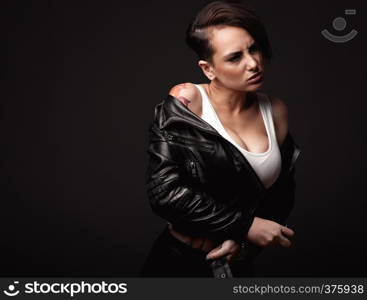 Beauty sexy woman in a leather jacket. Portrait on a dark background. Portrait of sexy caucasian woman