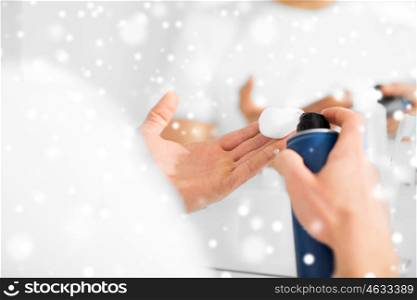 beauty, shaving, grooming and people concept - close up of man with shaving foam spray at home bathroom over snow